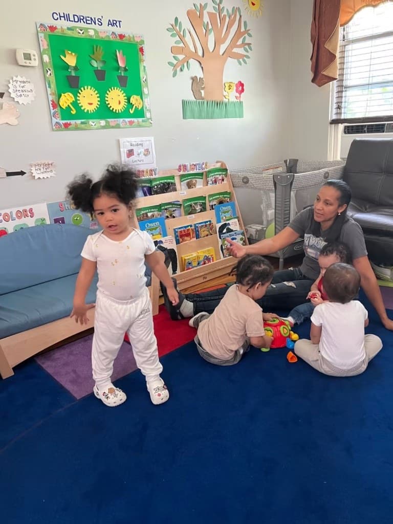 A teacher building with colorful blocks alongside children