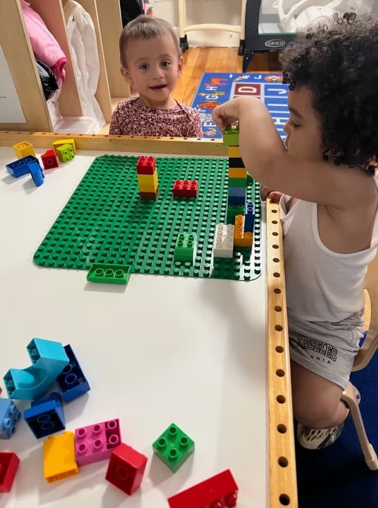 Children building with blocks at an activity table